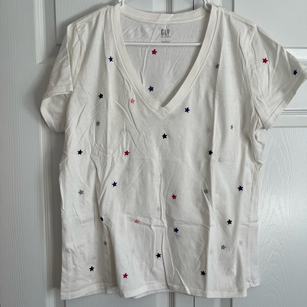 Gap tee. Light cream color with blue, silver, red and pink stars.